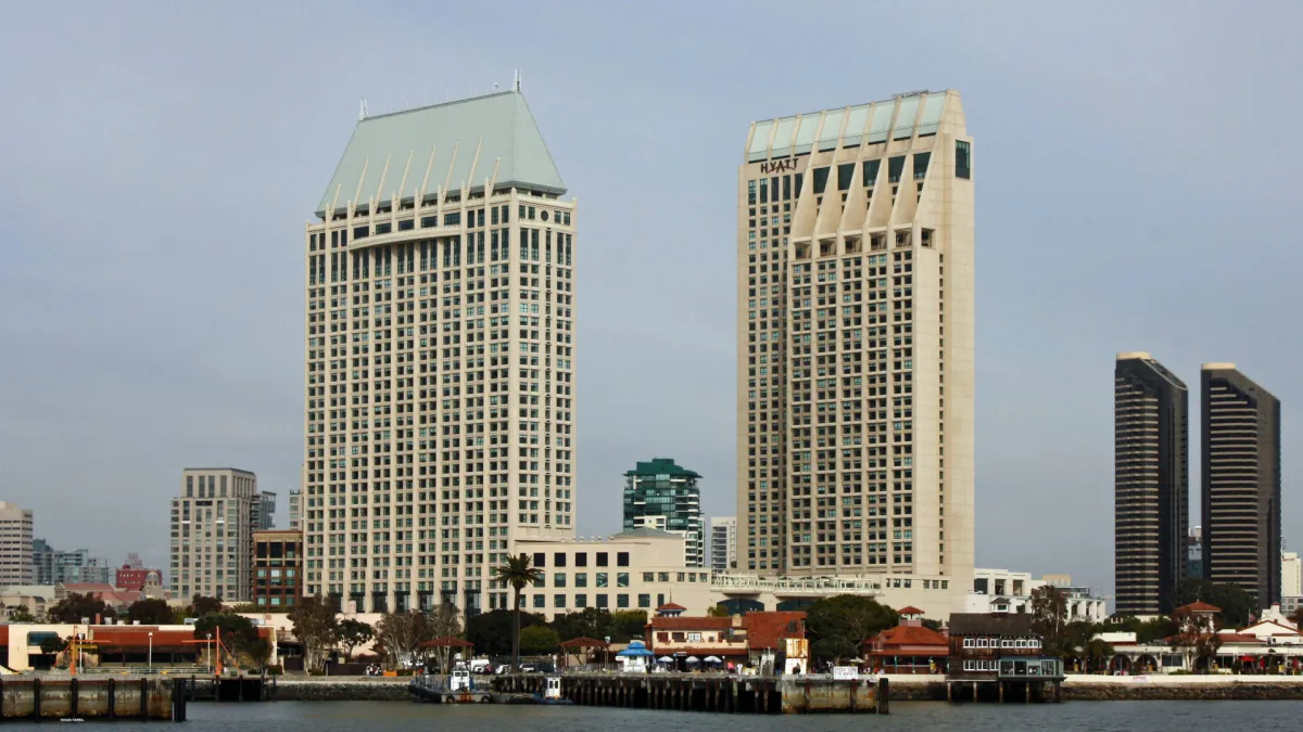 The twin towers of the Manchester Grand Hyatt seen across San Diego Bay, the Hyatt wordmark visible high on the nearer tower